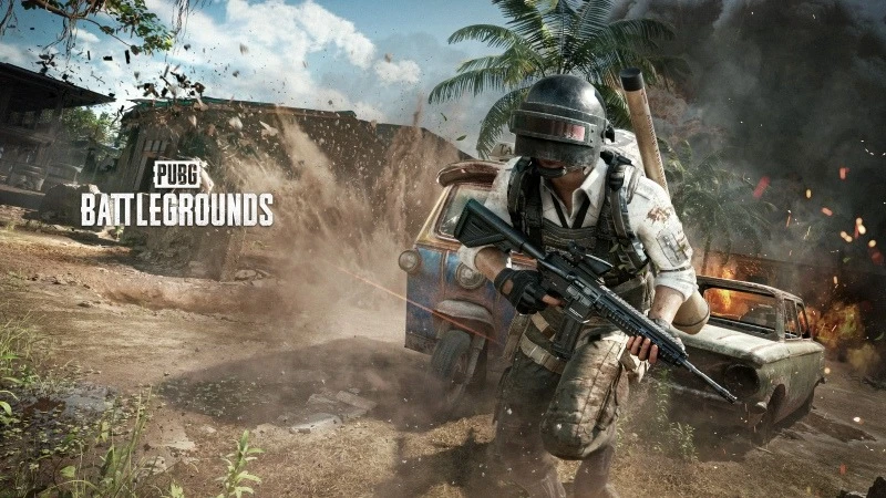 PUBG Mobile soldier armed with assault rifle in battle scene on tropical map.